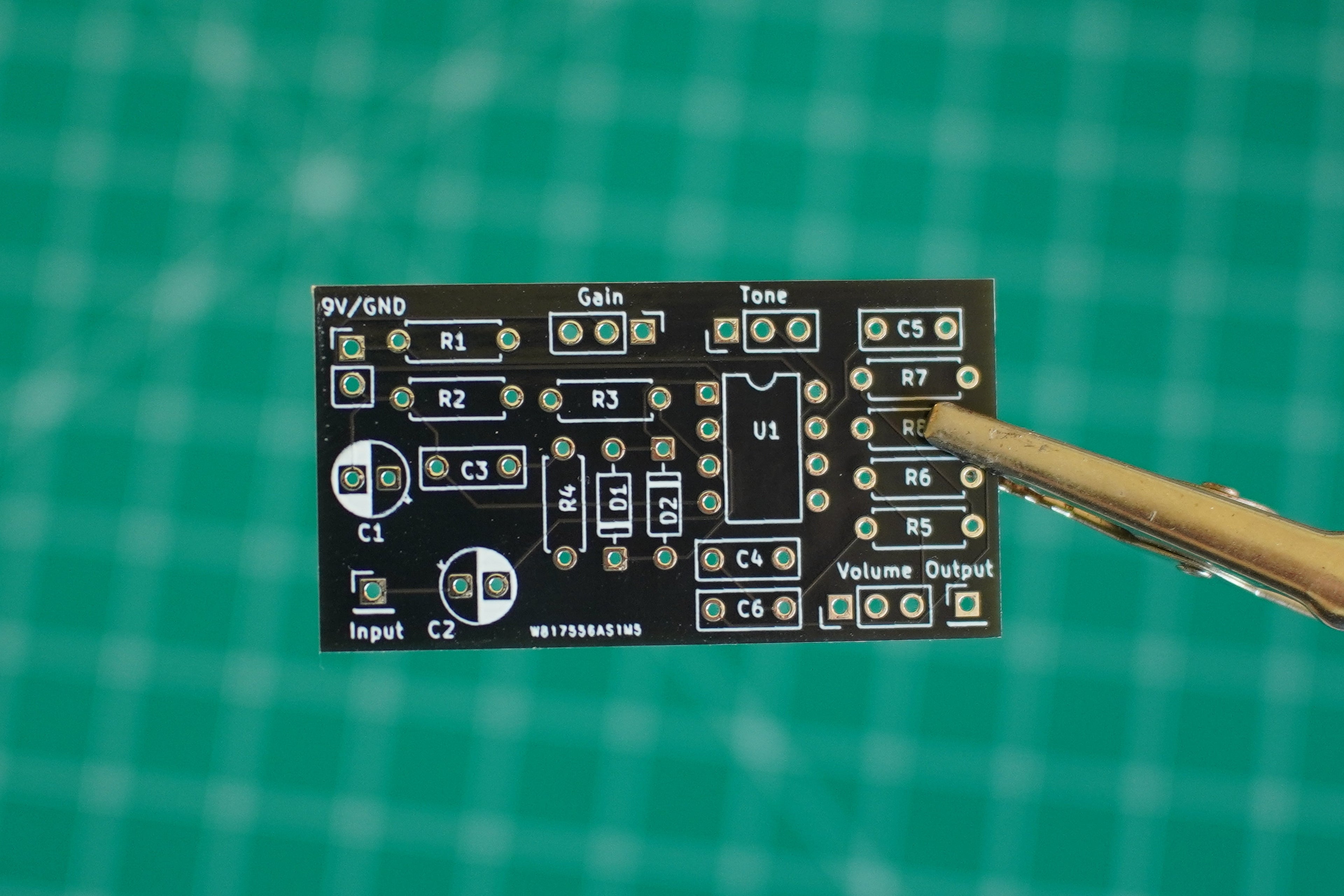 Circuit board with components on a green grid background